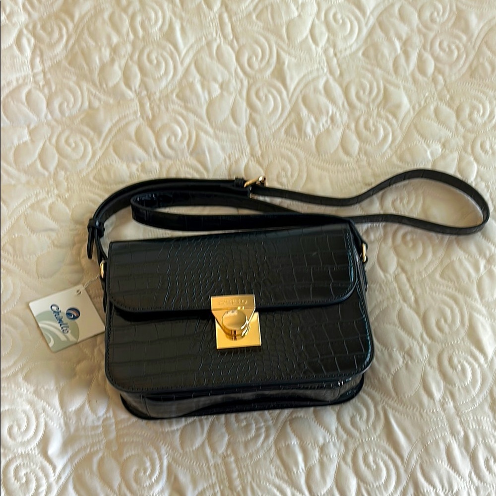 Never used crossbody bag  measures 9.3 x 6.9
Zippered pocket on the inside